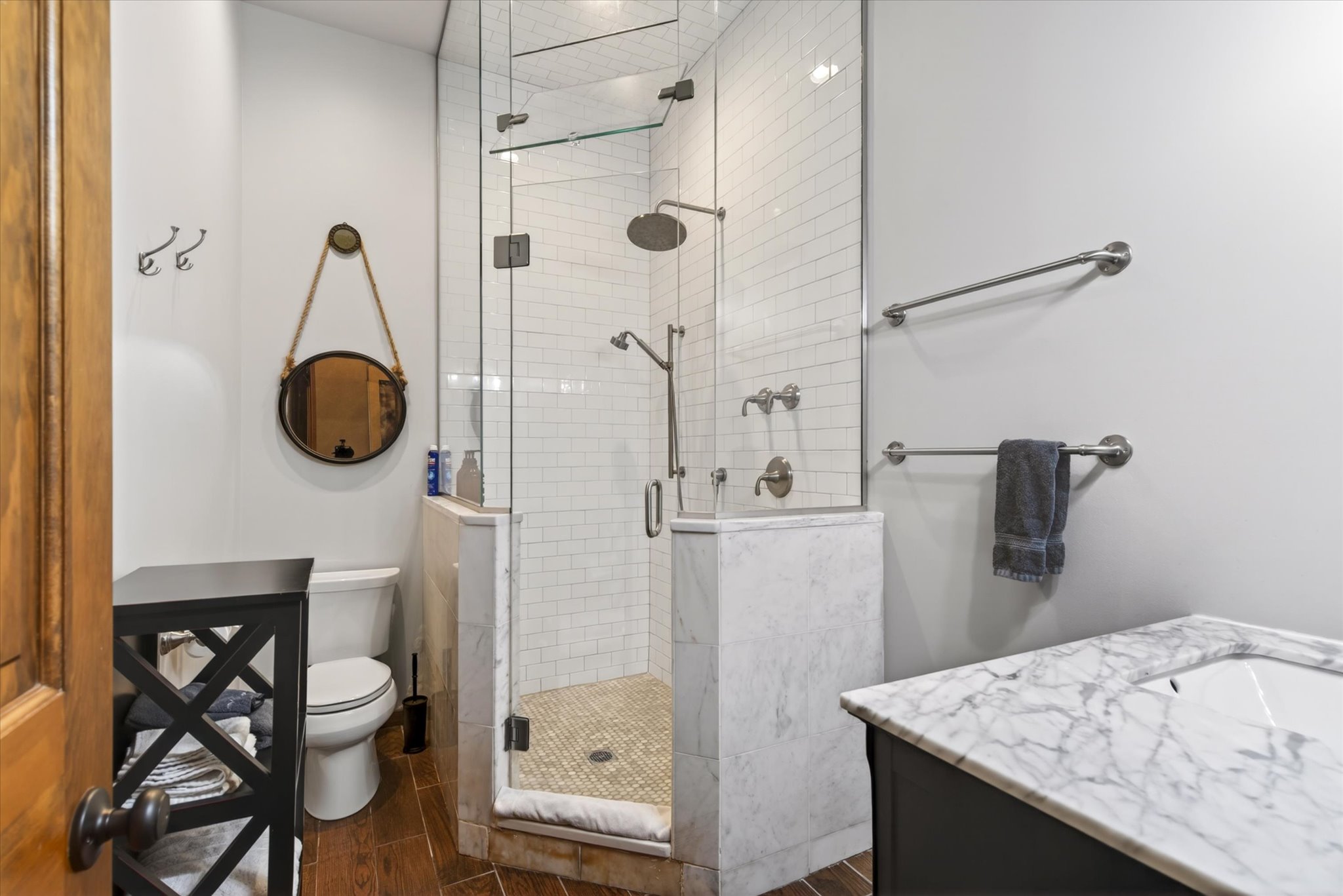 Lower bathroom marble shower with rain head and curated spa-quality bath amenities — Slippery Slope Chalet