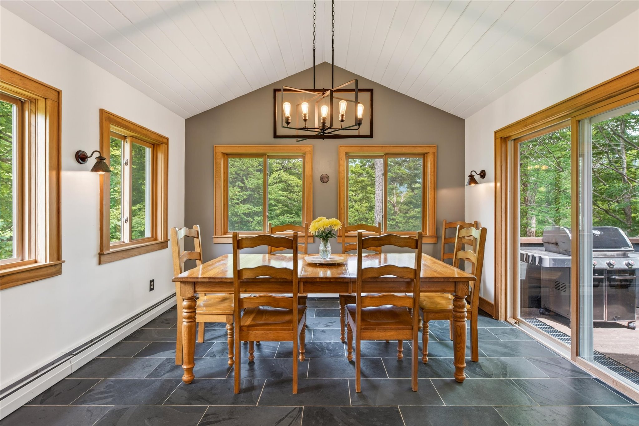 Dining room with 8-seat farm table and chandelier — Slippery Slope Chalet