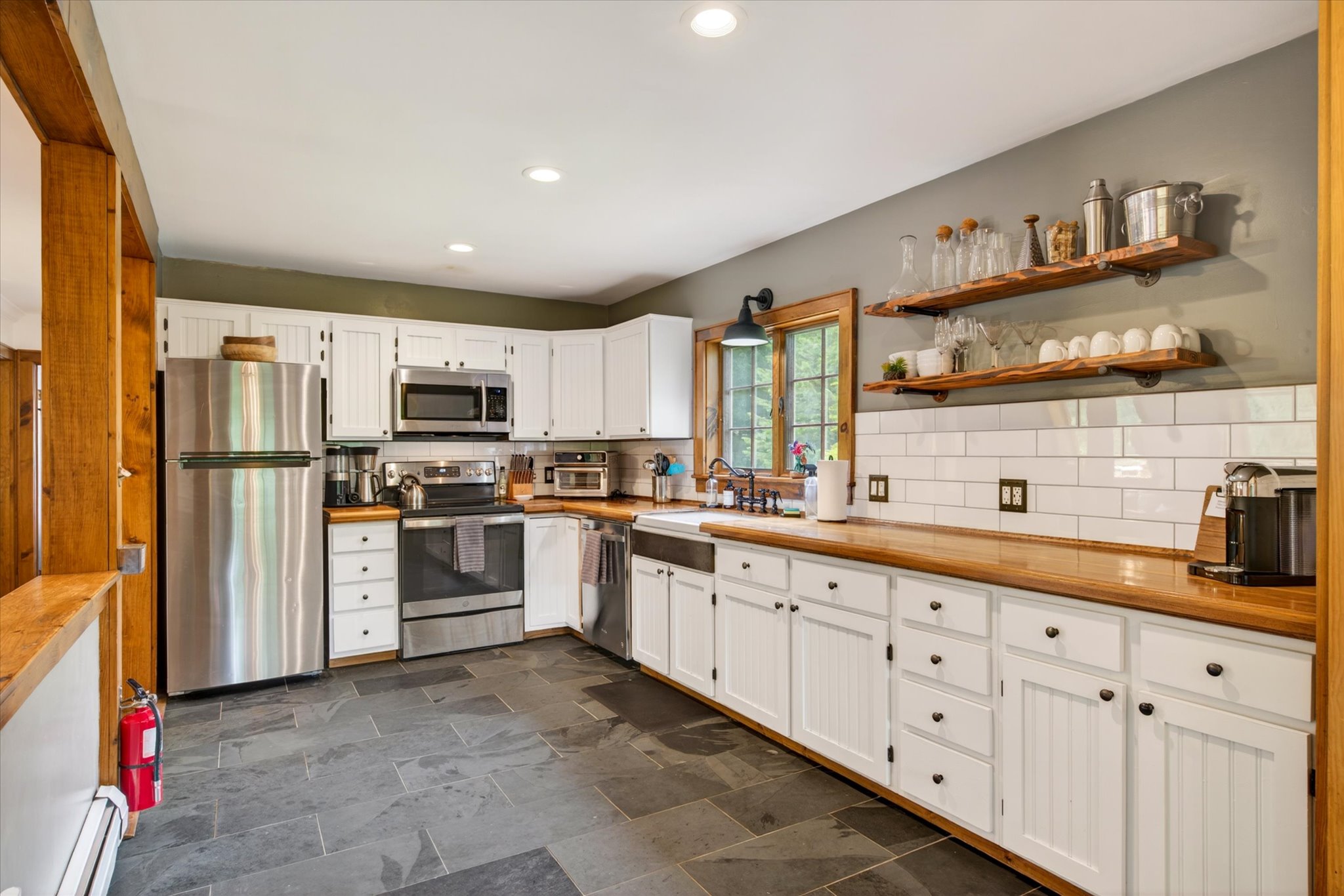 Kitchen with white cabinets and butcher block counters — Slippery Slope Chalet
